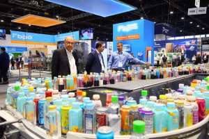 Attendees at PACK EXPO International 2026 in Chicago watch a live beverage bottle conveyor demonstration